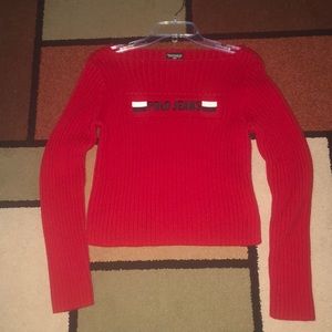 Red Polo 💯 cotton.  Hand wash, lay flat to dry